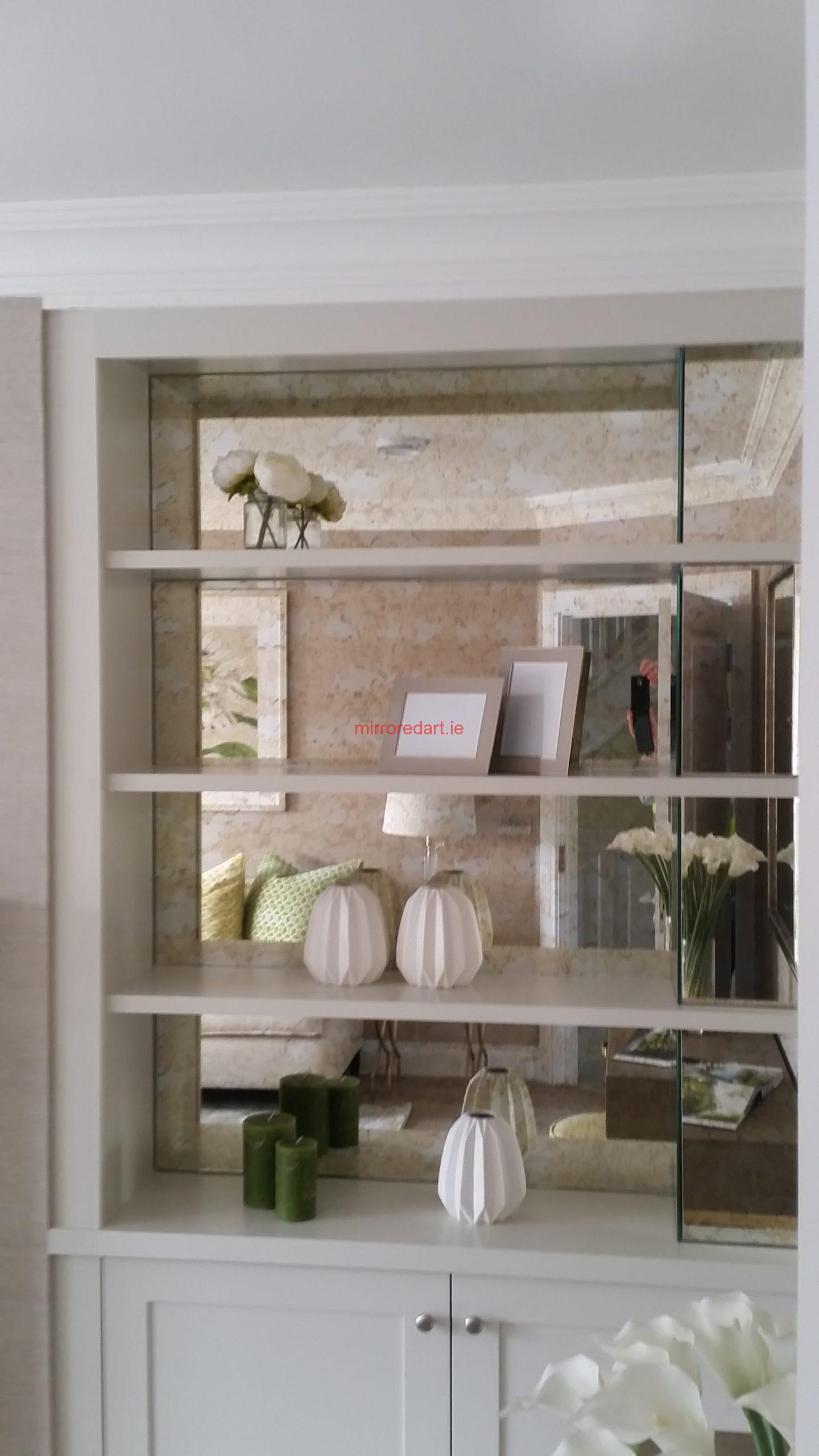 Mirrored book shelves in a beautiful amber antique/distressed mirror,giving lovely depth to the room.The Ardilea estate Clonskeagh Dublin