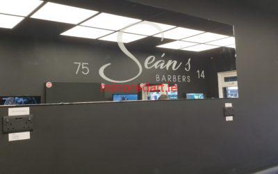 A large polished mirror with reverse sandblasted writing