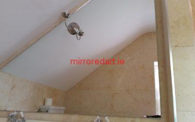 Angled bevelled mirror drilled to take a light through the mirror. Co Meath.