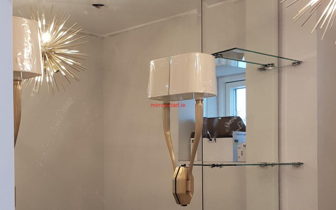 Bathroom  mirror with vertical lights and glass shelves.  Taylor’s Hill Galway.
