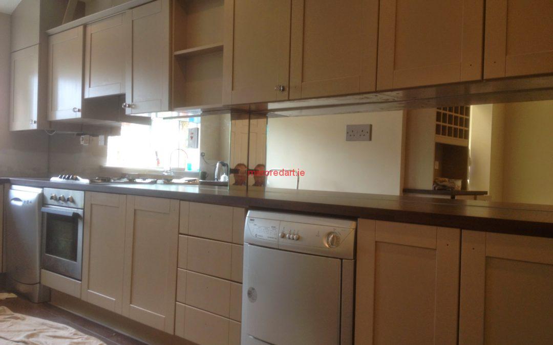 Silver mirrored splash back with cut outs for the electrical sockets for a house in Lusk North co Dublin.