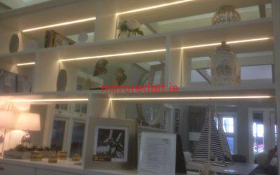 Mirrors set into bookshelves with led lighting, giving incredible depth to the room.