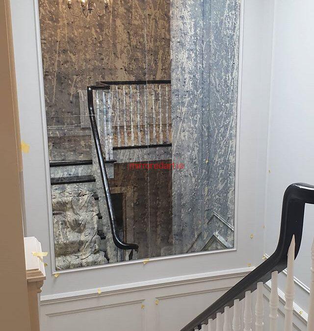 One of our Anitque mirrors in a frame on the turn of a stairs reflecting more light to the hall downstairs.