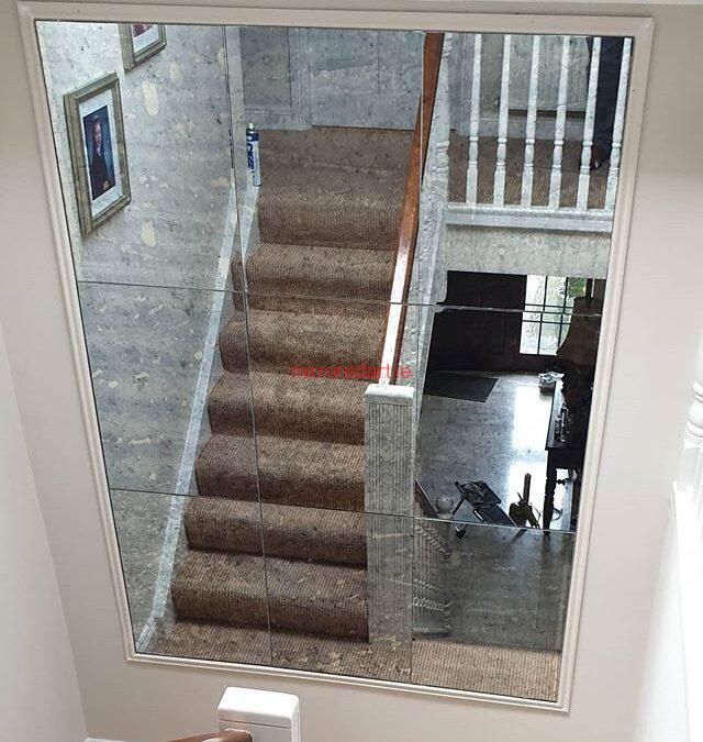 One of our Anitque mirrors in a frame on the turn of a stairs reflecting more light to the hall downstairs.